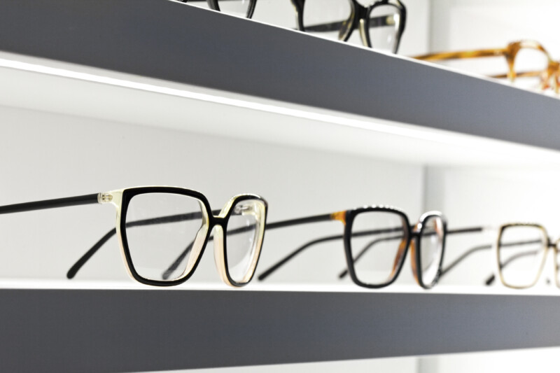 Stylish design glasses on shelves in a shop