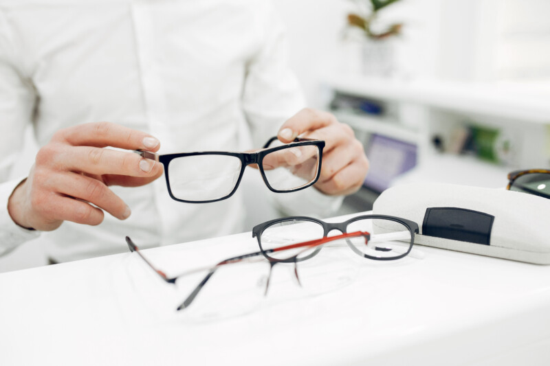 Man in a glasses. Guy in a optics shop